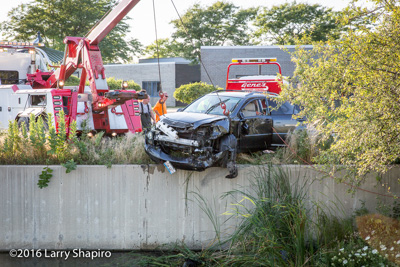 Gene's Towing recovers a car from a retaining wall over a pond in Wheeling IL 8-8-16 Larry Shapiro photographer shapirophotography.net